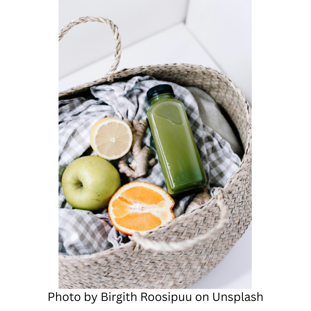 Photo by Birgith Roosipuu on Unsplash This is a things that are commonly used for a spring cleanse, tucked into a basket. The basket is of a brown woven material with handles and contains a checkered cloth holding a bottle of green juice, half an orange, half a lemon, and a green apple.