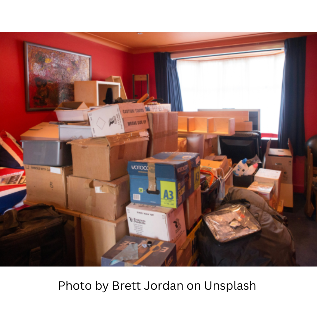 Photo by Brett Jordan on Unsplash This image shows the overwhelm created by moving. It depicts a room filled with a pile of packed boxes. Living in this kind of chaos can easily create a state of brain fog and overwhelm.